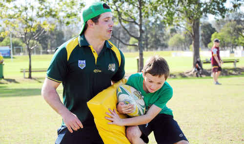 Mike Castle instructs Jacob Ford, 10, in the art of tackling at his football clinic at Advocate Park. Mike Castle instructs Jacob Ford, 10, in the art of tackling at his football clinic at Advocate Park.